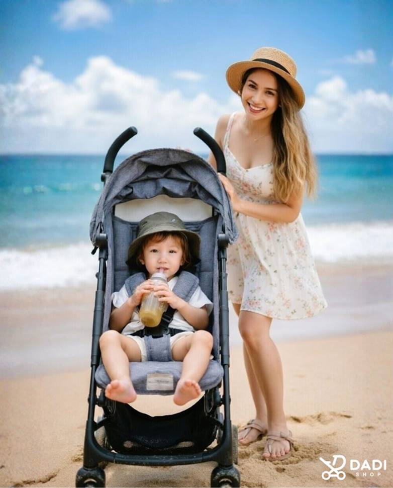 Mama z 4-letnim chłopcem w lekkiej spacerówce typu parasolka na plaży podczas wakacji.